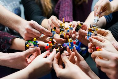 Hands holding minifigures