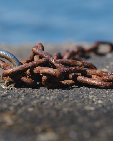 Closeup of old chains on the dock